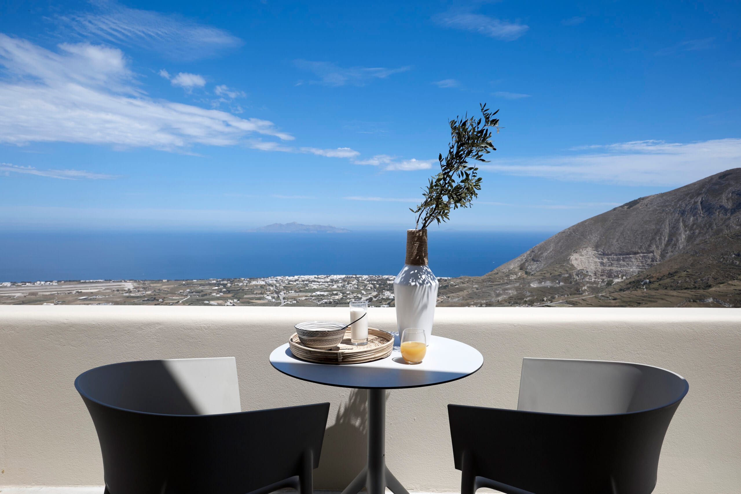 Terrace at Star Infinity Suites overlooking the Aegean Sea and the mountains of Santorini